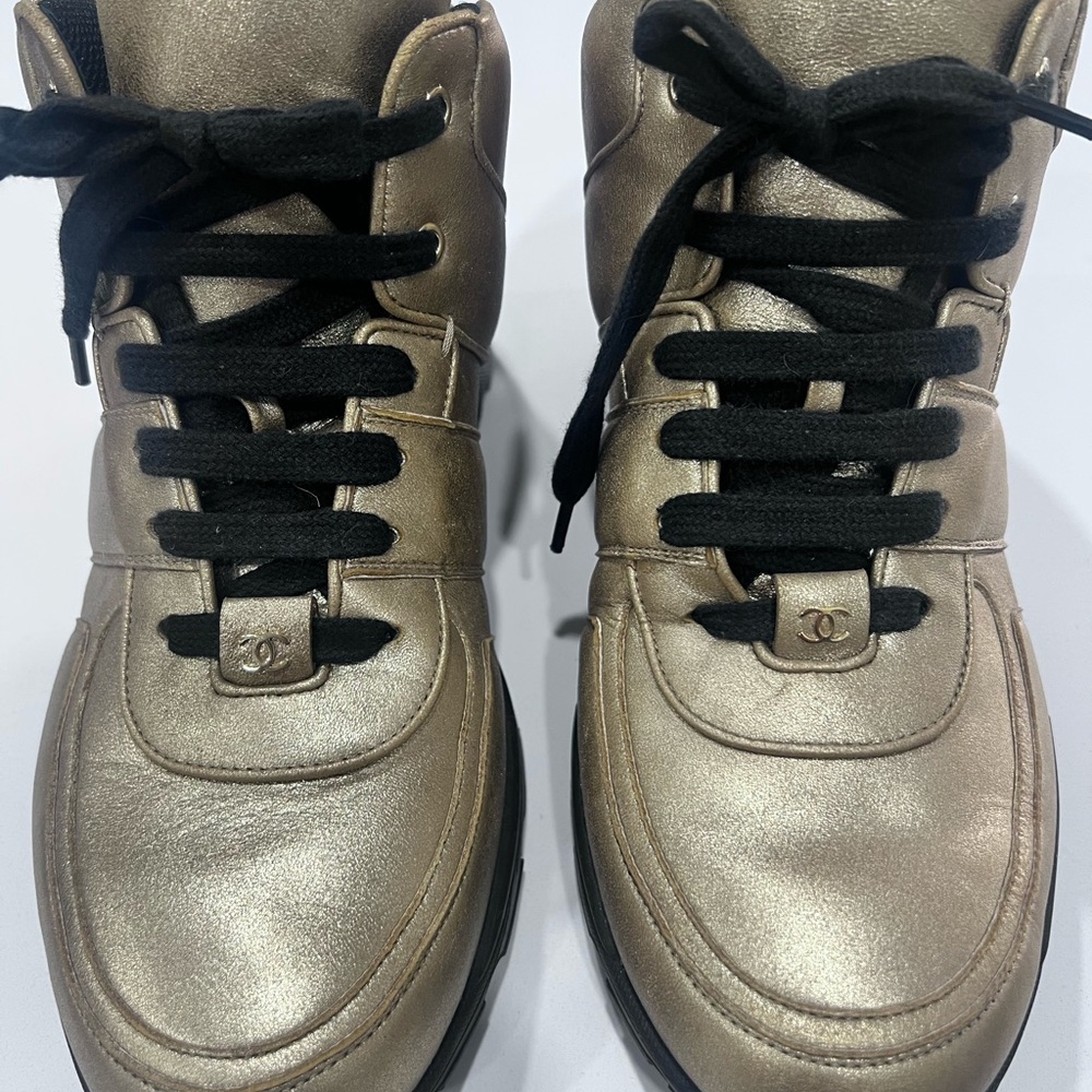CHANEL Metallic Gold Sneakers with Black Accents